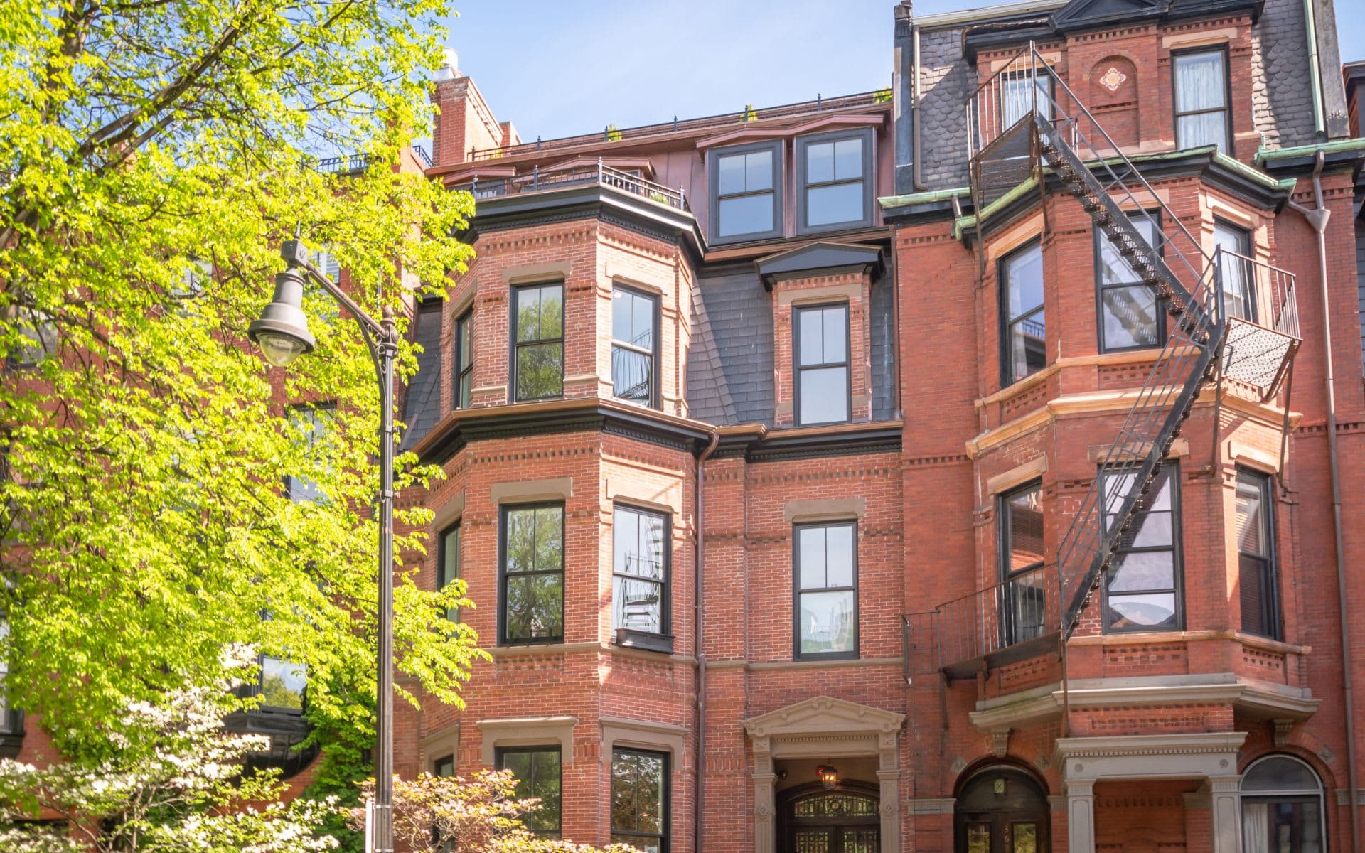 Brick bowfront row houses on a Boston street