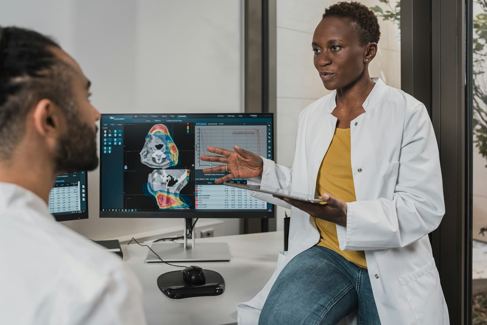 A physician reviewing scans with a colleague